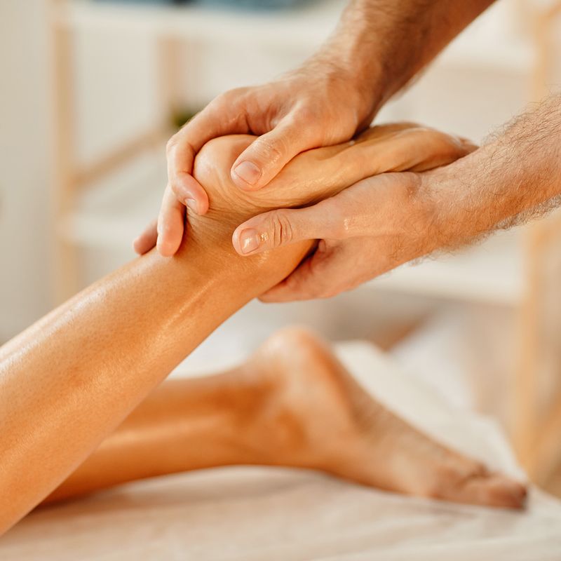 Massage therapist giving an effective foot massage
