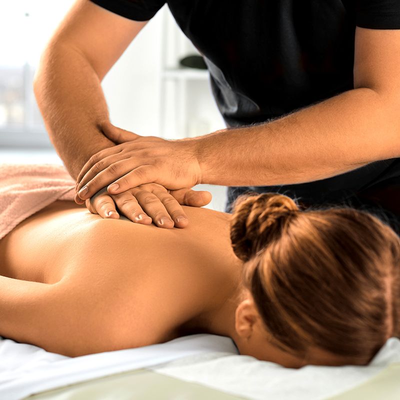 Massage therapist giving a healing back massage